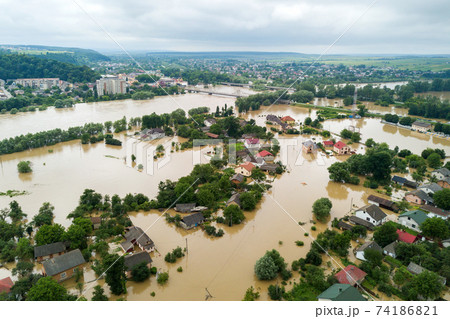 Aerial view of flooded houses with dirty water of Dnister river in Halych town, western Ukraine. Aerial view of flooded houses with dirty water of Dnister river in Halych town, western Ukraine. 74186821