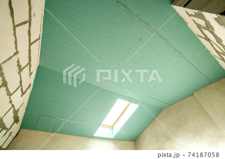 Interior of an apartment room with bare walls and ceiling under construction. Interior of an apartment room with bare walls and ceiling under construction. 74187058