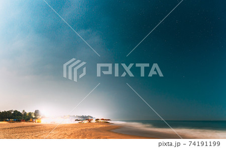 Goa, India. Real Night Sky Stars. Natural Starry Sky In Blue Color Above Indian Ocean Sea Seascape Beach Copast. Background 74191199