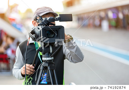 Video camera operator working with his equipment. video cinema production.  74192874