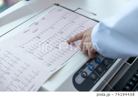 Doctor holding a cardiogram test. Doctor holding a cardiogram test. 74194438