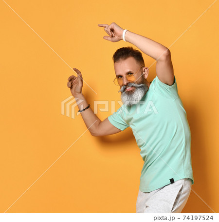 Positive smiling bearded man dancing studio shot 74197524