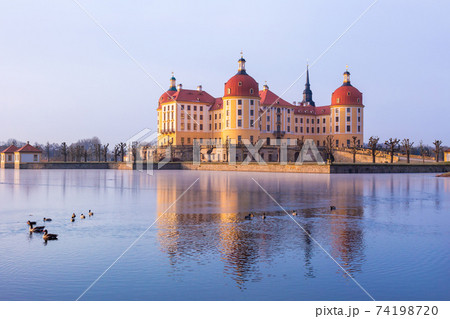 Moritzburg castle after sunrise at winter time, Germany 74198720