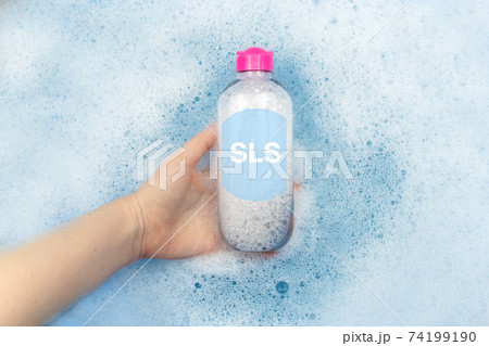 A bottle of micellar water floating in soapy water. Harmful composition of ingredients. Cleanser with SLS. The concept of hazardous substances in cosmetics and household chemicals A bottle of micellar water floating in soapy water. Harmful composition of ingredients. Cleanser with SLS. The concept of hazardous substances in cosmetics and household chemicals 74199190