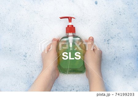 A bottle of liquid soap floating in soapy water. Harmful composition of ingredients, detergent with SLS. The concept of hazardous substances in cosmetics and household chemicals 74199203