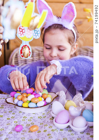 Easter. Little girl with colored eggs and chocolate colored eggs. Happy Easter holiday at home Easter. Little girl with colored eggs and chocolate colored eggs. Happy Easter holiday at home 74199492