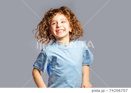 little girl jumps on a gray background little girl jumps on a gray background 74206707