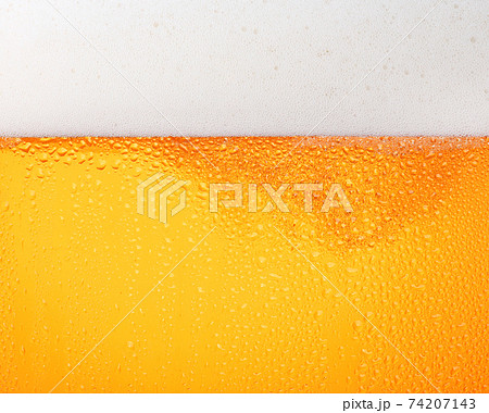 Close up background of beer with bubbles in glass Close up background of beer with bubbles in glass 74207143