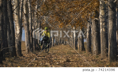 The woman travel on mixed terrain cycle touring with bikepacking. The traveler journey with bicycle bags. Sport tourism bikepacking. 74214396