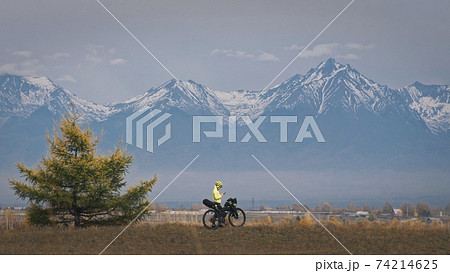 The woman travel on mixed terrain cycle touring with bikepacking. The traveler journey with bicycle bags. Sport tourism bikepacking. The woman travel on mixed terrain cycle touring with bikepacking. The traveler journey with bicycle bags. Sport tourism bikepacking. 74214625