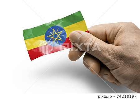 Hand holding a card with a national flag the Ethiopia 74218197