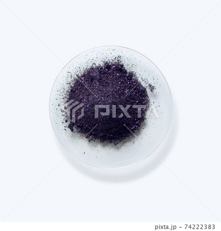 Close up inorganic chemical on white laboratory table. Potassium permanganate (KMnO4), a common chemical compound that combines manganese oxide ore with potassium hydroxide. Close up inorganic chemical on white laboratory table. Potassium permanganate (KMnO4), a common chemical compound that combines manganese oxide ore with potassium hydroxide. 74222383