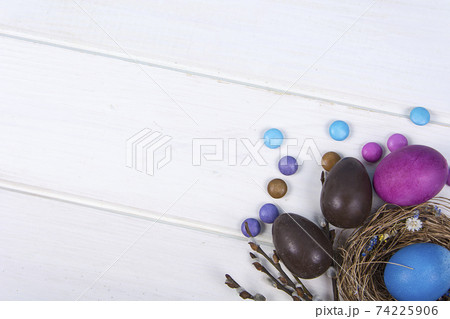 Colorful background with Easter eggs on white wooden board background. Happy Easter concept. Can be used as poster, background, holiday card. 74225906