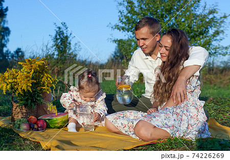 Portrait of a happy family in the park-an outdoor photo. Family photo shoot 74226269