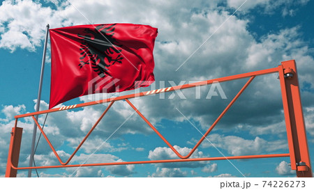 Swing arm road barrier and flag of Albania, entry ban related 3d rendering 74226273