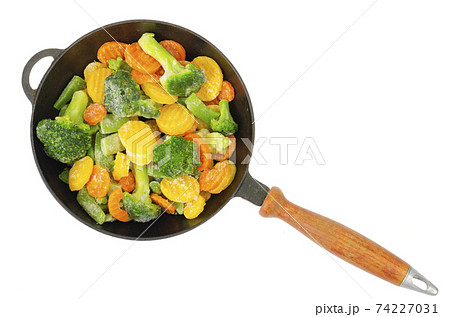 Pan with frozen pieces of vegetables isolated on white background. Studio Photo 74227031