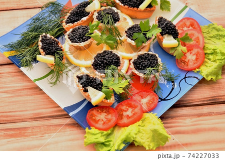 Tartlets with black caviar 74227033