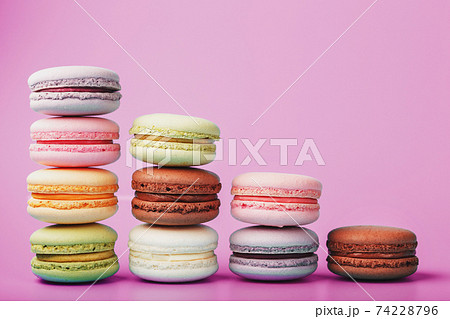 Colorful French macaroni cookies are arranged in a pyramid on the background. 74228796