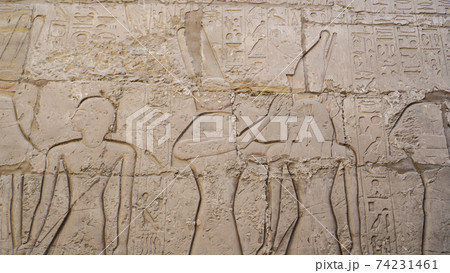 Luxor Egypt Karnak temple sandstone craved hieroglphic wall and column pharoah anceint story Luxor Egypt Karnak temple sandstone craved hieroglphic wall and column pharoah anceint story 74231461