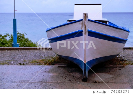 Lonely boat on a stormy seashore 74232275