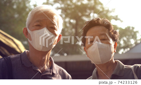 Hopeless Asian Chinese couple aware of 2019 ncv outbreak and smog situation wear preventing mask Hopeless Asian Chinese couple aware of 2019 ncv outbreak and smog situation wear preventing mask 74233126