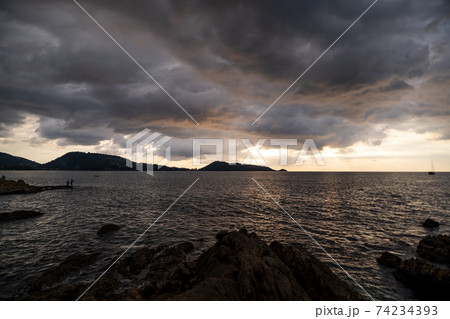 Dark storm cloud Rain clouds over sea in sunset or sunrise sky Dramatic black cloudscape in bad weather day Horrible weather day Dark storm cloud Rain clouds over sea in sunset or sunrise sky Dramatic black cloudscape in bad weather day Horrible weather day 74234393