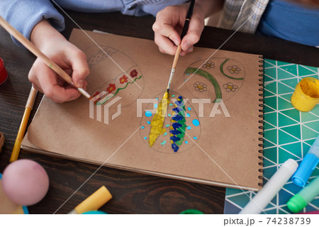 Children painting eggs on paper Children painting eggs on paper 74238739