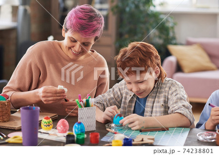 Family decorating Easter eggs Family decorating Easter eggs 74238801