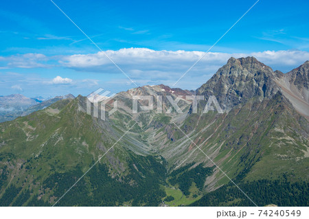 View into a typical trough valley in the Grisons mountains, Switzerland 74240549