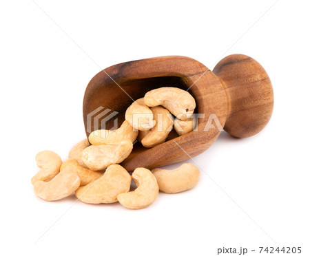 Cashew nuts in wooden scoop, isolated on white background. Roasted cashew nuts. 74244205