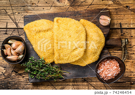 Cordon bleu meat cutlets with bread crumbs on a wooden board. wooden background. Top view 74246454