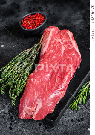Raw flank beef meat steak. Black background. Top view Raw flank beef meat steak. Black background. Top view 74246670