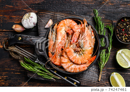 Red Tiger shrimps Prawns in a pan. Dark wooden background. Top view 74247461