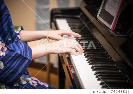 Playing the piano in a kimono 74248815