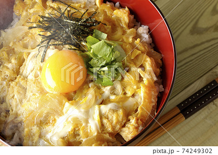卵黄、みつば、刻み海苔の乗っている玉子丼とお箸(俯瞰) 卵黄、みつば、刻み海苔の乗っている玉子丼とお箸(俯瞰) 74249302