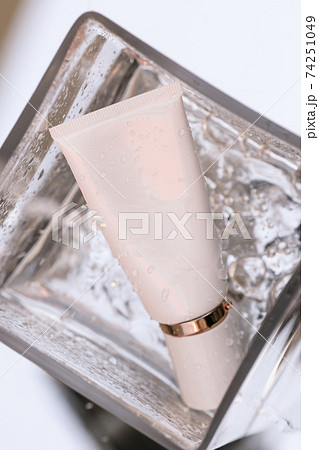 Cosmetic bottle in a bowl with water mininmalist beauty 74251049