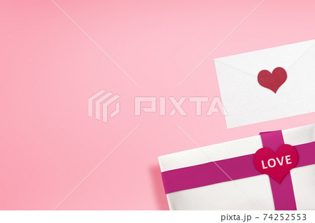 White gift box with a red ribbon and heart shape with LOVE text and envelope White gift box with a red ribbon and heart shape with LOVE text and envelope 74252553