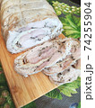 chicken roll with omelette and spices on a wooden board. 74255904