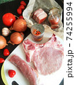 fresh, raw pork entrecote on a board, spices and vegetables. 74255994