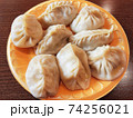 traditional manti with lamb and spices on a plate on the table. 74256021
