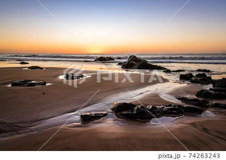 Scenic view of beach against sky during sunset 74263243