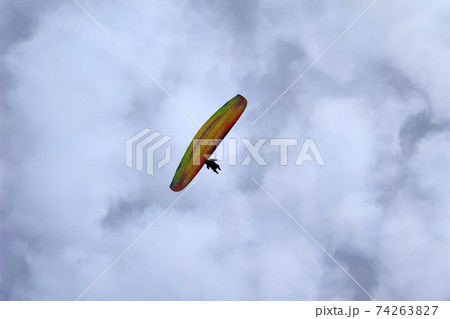 paraglider on cloudy sky 74263827
