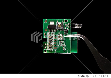 Internet of Things (IoT) system on a chip (SOC) integrated circuit computer with small microchip microcontroller isolated on black background. 74264181