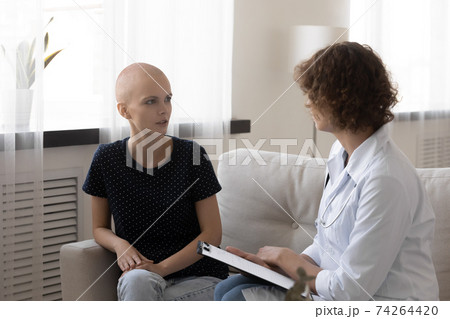 Doctor talk with hairless female cancer patient at consultation 74264420