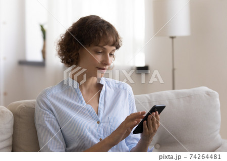 Woman relax at home using smartphone gadget Woman relax at home using smartphone gadget 74264481