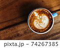 Cappuccino in a blue mug on a wooden table. Coffee view from above 74267385