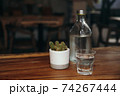 Drinking water. Glass of water with a bottle on table 74267444
