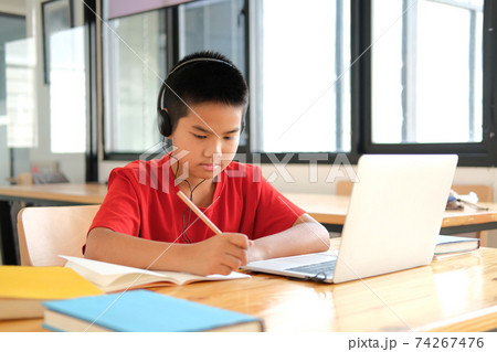 boy student studying learning lesson online. remote meeting distance education at home boy student studying learning lesson online. remote meeting distance education at home 74267476