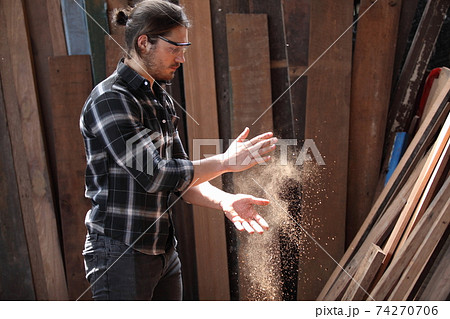 Carpenter, he is working in the workshop. Man at work on wood. Image of mature carpenter in the workshop, furniture making concept. Carpenter, he is working in the workshop. Man at work on wood. Image of mature carpenter in the workshop, furniture making concept. 74270706