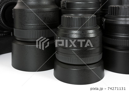 Collection of professional and modern lenses and DSLR camera in close-up. 74271131